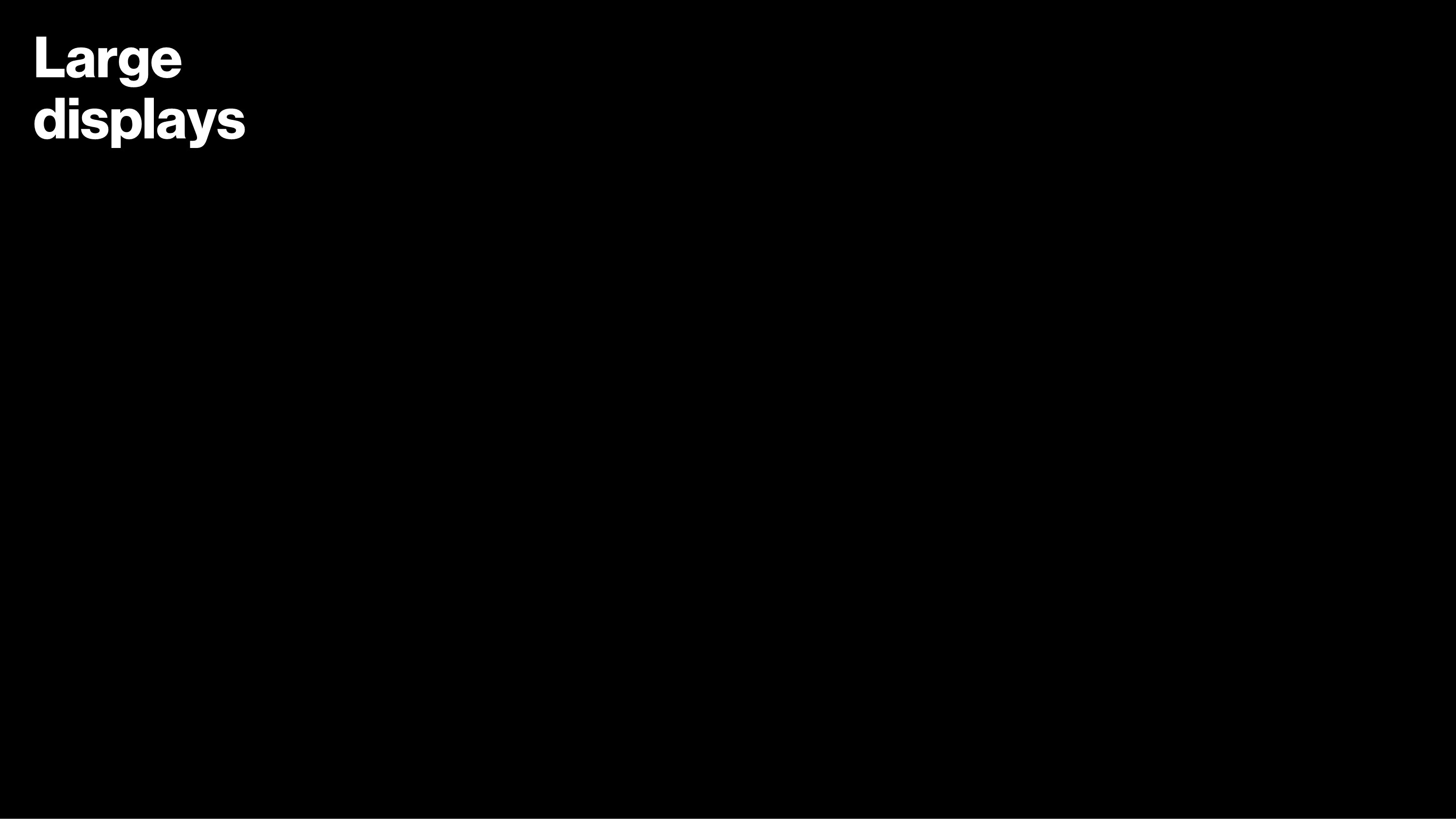 Minimalist slide featuring the text 'Large displays' in white on a black background, showcasing typography as a core element within Verizon's future of retail design presentation.